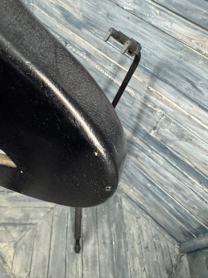 Black car mirror on a textured gray surface