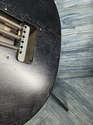 Metal bracket on a wooden surface with a wooden floor background