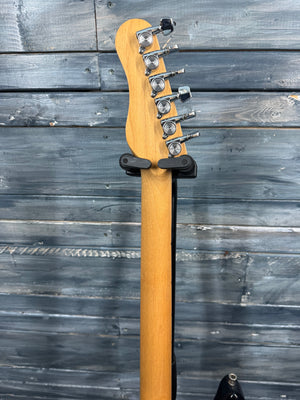 Guitar neck with headstock on a wooden surface
