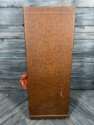 Brown wooden panel with a visible brand logo on a wooden surface