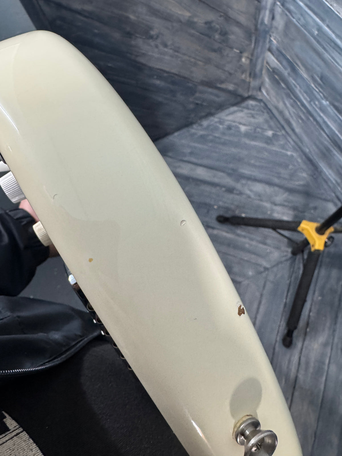 Close-up of a white scooter seat with a blurred background