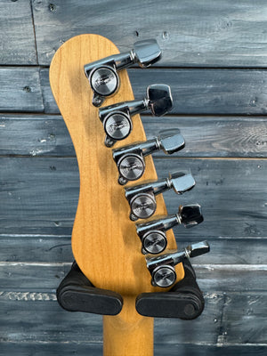 Guitar headstock with tuning pegs on a wooden background