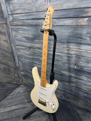 Electric guitar on a stand against a wooden wall