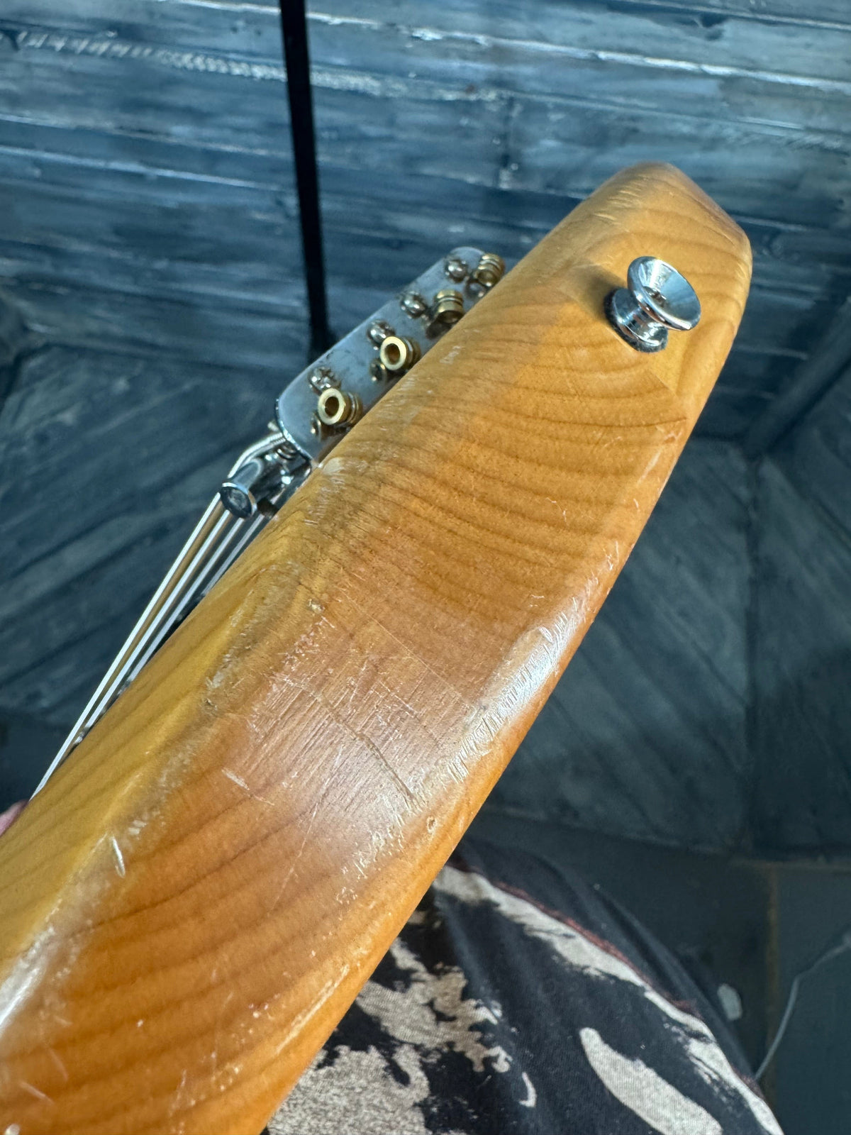 Wooden folding knife with metal blade on a textured surface