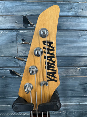 Guitar headstock with 'Yamaha' branding against a wooden background