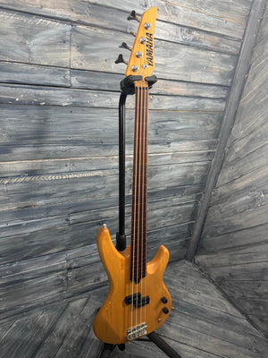 Yellow bass guitar on a wooden floor