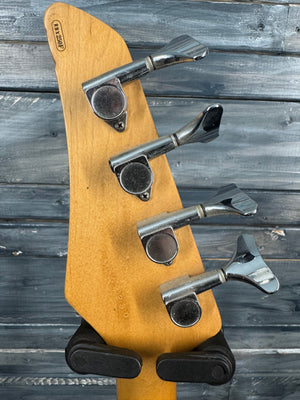 Close-up of a guitar's tuning pegs against a wooden background