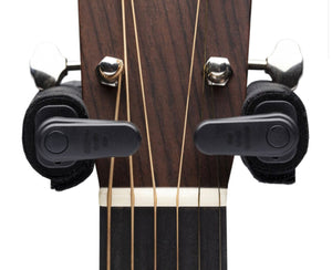 close up of guitar hanging on hanger