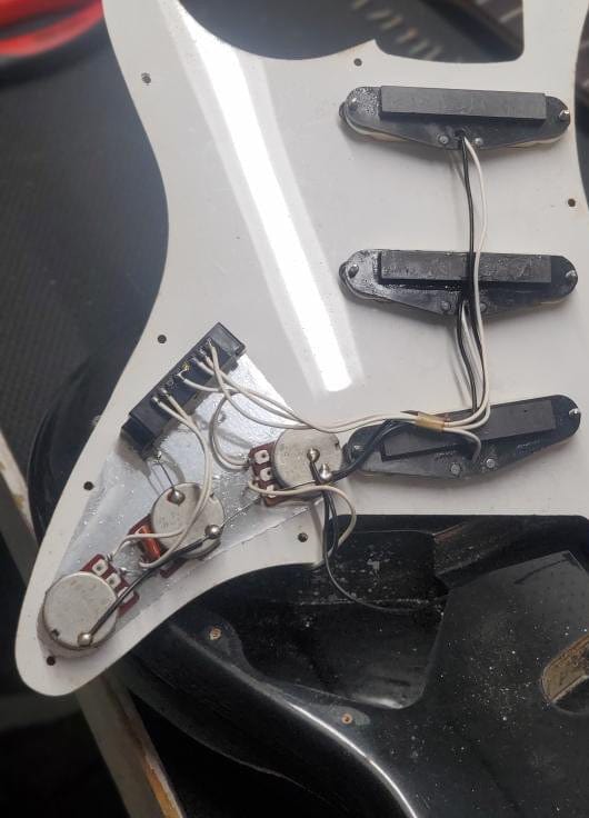 Used Squier back of the pickguard